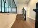 Landing with wood-look floors, railing, and staircase with dark metal railing at 987 Hawksnest Pt, Oviedo, FL 32765