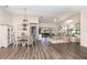 Open concept dining area with white table and chairs, hardwood floor at 139 Stratford Ct, Haines City, FL 33844