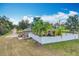 Aerial view of the house with a large yard, privacy fence, and several palm trees at 24217 Adair Ave, Sorrento, FL 32776