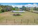 Aerial view of the house with a large yard, privacy fence, and several palm trees at 24217 Adair Ave, Sorrento, FL 32776
