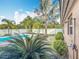 Backyard with a pool, palm trees, white fence and an outdoor shower at 24217 Adair Ave, Sorrento, FL 32776