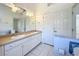 Bright bathroom with double vanity, white cabinets, and ample storage space, perfect for a couple at 24217 Adair Ave, Sorrento, FL 32776