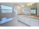 Bright bathroom featuring double sinks, a spacious vanity, and a combination shower and tub at 24217 Adair Ave, Sorrento, FL 32776