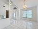 Inviting foyer with white tile and view to open dining space with chandelier at 24217 Adair Ave, Sorrento, FL 32776