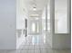 Inviting foyer with white tile, shelf, and view to open dining space at 24217 Adair Ave, Sorrento, FL 32776