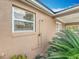 Exterior home feature with a shower, window and partial view of the lanai at 24217 Adair Ave, Sorrento, FL 32776