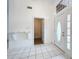 Bright foyer with tile flooring and a decorative shelf, leading into other rooms at 24217 Adair Ave, Sorrento, FL 32776