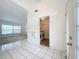 Welcoming foyer featuring tile flooring, an open doorway, and a convenient laundry area at 24217 Adair Ave, Sorrento, FL 32776