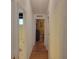 Hallway with light walls and wood flooring leading to bedrooms at 24217 Adair Ave, Sorrento, FL 32776