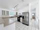 Bright kitchen with stainless steel refrigerator and black appliances at 24217 Adair Ave, Sorrento, FL 32776
