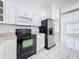 Kitchen featuring stainless steel refrigerator and black oven at 24217 Adair Ave, Sorrento, FL 32776