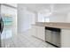 View of kitchen with stainless steel dishwasher and white cabinets at 24217 Adair Ave, Sorrento, FL 32776