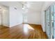 Bright living room featuring hardwood floors, ceiling fan, and sliding glass doors at 24217 Adair Ave, Sorrento, FL 32776