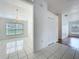 Open living room featuring chandelier and tile flooring, bright natural light at 24217 Adair Ave, Sorrento, FL 32776