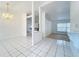 Bright living room with tile flooring, chandelier, and open layout, perfect for modern living at 24217 Adair Ave, Sorrento, FL 32776