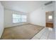 Bright, carpeted living room with large window and white walls at 24217 Adair Ave, Sorrento, FL 32776