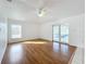 Bright living room with hardwood floors and a ceiling fan at 24217 Adair Ave, Sorrento, FL 32776