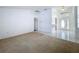 Open living room with tile flooring leading to bright front entry at 24217 Adair Ave, Sorrento, FL 32776