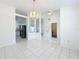 Open living space with white tile flooring, adjacent kitchen, and dining area at 24217 Adair Ave, Sorrento, FL 32776