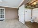 Enclosed patio featuring tiled flooring and adjacent outdoor half bathroom at 24217 Adair Ave, Sorrento, FL 32776