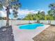 Relaxing backyard with large pool surrounded by tropical landscaping and a privacy fence at 24217 Adair Ave, Sorrento, FL 32776