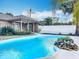 Backyard swimming pool surrounded by lush tropical landscaping and a privacy fence at 24217 Adair Ave, Sorrento, FL 32776