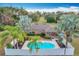 Aerial view of fenced pool, manicured landscaping, palm trees, lawn, and well-maintained home at 24217 Adair Ave, Sorrento, FL 32776