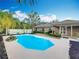 Relaxing backyard with large pool surrounded by tropical landscaping and a privacy fence at 24217 Adair Ave, Sorrento, FL 32776