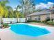 Backyard swimming pool surrounded by lush tropical landscaping and a privacy fence at 24217 Adair Ave, Sorrento, FL 32776