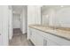 Bathroom featuring a granite countertop, double sinks, white cabinets, and tile flooring at 2735 Virginia Pine Dr, Bartow, FL 33830