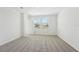 Bright bedroom features neutral carpet, white walls, and natural light from a window at 2735 Virginia Pine Dr, Bartow, FL 33830