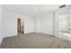 Spacious carpeted bedroom with a doorway to the bathroom and a large window at 2735 Virginia Pine Dr, Bartow, FL 33830
