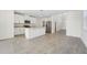 Contemporary kitchen features white cabinetry, stainless steel appliances, and an island with bar seating at 2735 Virginia Pine Dr, Bartow, FL 33830