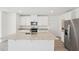 Bright kitchen with an island featuring a double sink, granite countertops, and stainless steel appliances at 2735 Virginia Pine Dr, Bartow, FL 33830