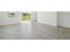 Bright open-plan living room with sliding glass doors and clean neutral tiling throughout at 2735 Virginia Pine Dr, Bartow, FL 33830