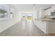 Bright open-concept living room and kitchen with tile flooring and sliding glass doors to the backyard at 2735 Virginia Pine Dr, Bartow, FL 33830