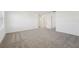 Spacious living room features neutral carpet, white walls, and natural light from a window at 2735 Virginia Pine Dr, Bartow, FL 33830