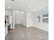 An open living space featuring a large window and leading to the foyer and kitchen at 2735 Virginia Pine Dr, Bartow, FL 33830