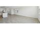 Spacious open living area with tile floors and natural light, adjacent to the kitchen at 2735 Virginia Pine Dr, Bartow, FL 33830