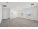 Spacious upstairs loft featuring neutral carpet, white walls, and natural light from windows at 2735 Virginia Pine Dr, Bartow, FL 33830