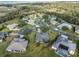 Aerial view of a community with tree-lined streets and mature landscaping at 27601 Country Stone Ct, Leesburg, FL 34748