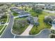 Aerial view of a home in a well-maintained neighborhood near a lake at 27601 Country Stone Ct, Leesburg, FL 34748