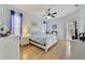 Tranquil bedroom with a white bed, ceiling fan, and bright natural light at 27601 Country Stone Ct, Leesburg, FL 34748