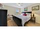 Cozy bedroom with a comfortable bed, ceiling fan, and natural light streaming through the window at 27601 Country Stone Ct, Leesburg, FL 34748
