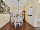 Charming dining area features wood floors, chandelier, and room for entertaining at 27601 Country Stone Ct, Leesburg, FL 34748