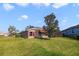 Exterior view of a single-story house with a well-maintained lawn at 27601 Country Stone Ct, Leesburg, FL 34748