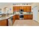Well-equipped kitchen with stainless appliances, backsplash, and ample cabinet space at 27601 Country Stone Ct, Leesburg, FL 34748