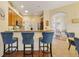 Open kitchen with breakfast bar seating, cabinets, and tile flooring at 27601 Country Stone Ct, Leesburg, FL 34748