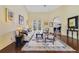 Bright living room with high ceilings, comfortable seating, hardwood floors, and sliding glass doors to the patio at 27601 Country Stone Ct, Leesburg, FL 34748
