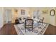 Inviting living room with neutral walls, area rug, and access to the outdoors at 27601 Country Stone Ct, Leesburg, FL 34748